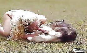 Long hair blonde sucks dog